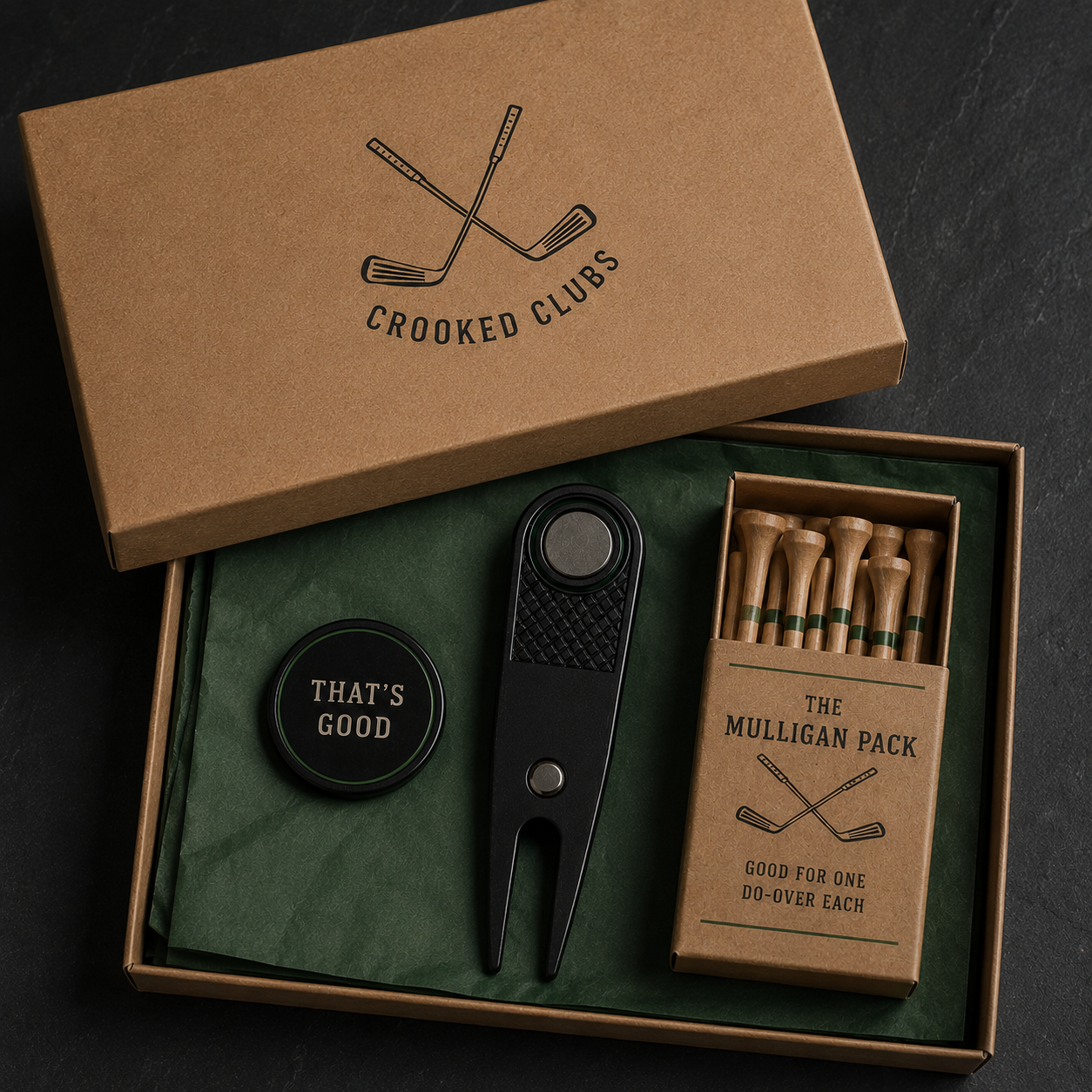 Kraft gift box with the Crooked Clubs logo holding a ball marker, divot tool, and Mulligan Pack